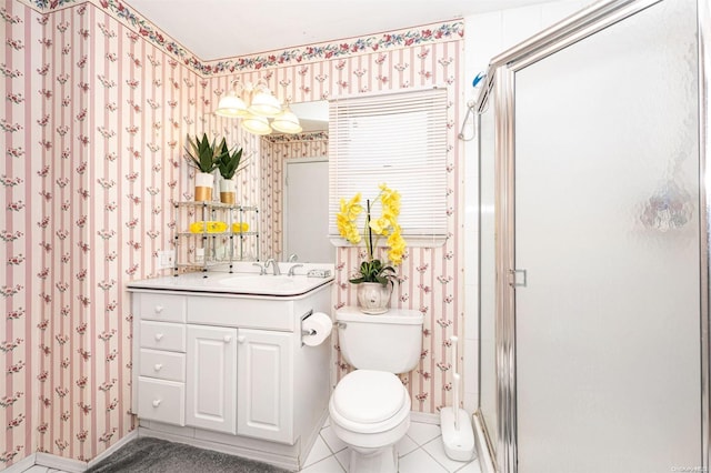 bathroom featuring tile patterned floors, vanity, an enclosed shower, and toilet