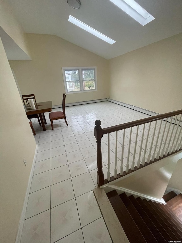 stairs featuring lofted ceiling with skylight and tile patterned flooring