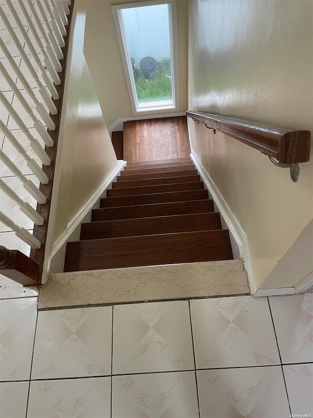 stairway featuring wood-type flooring