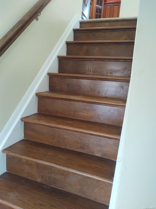 stairway featuring wood-type flooring