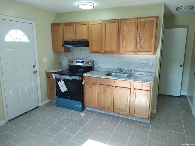 kitchen with black electric range, decorative backsplash, light tile patterned flooring, and sink