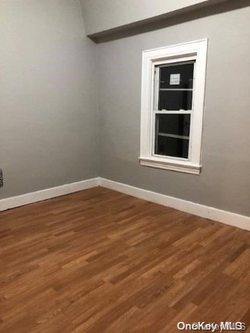 empty room featuring dark wood-type flooring