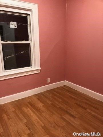 empty room with hardwood / wood-style flooring