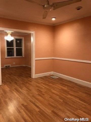 empty room with hardwood / wood-style flooring and ceiling fan