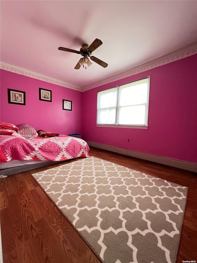 1626 Park Ave, New Hyde Park, NY 11040 - bedroom featuring a baseboard heating unit, wood finished floors, ceiling fan, and baseboards