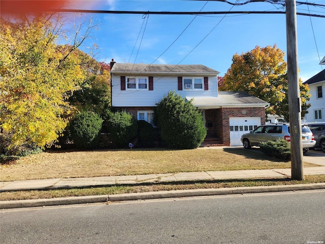 view of front facade with a front yard and a garage