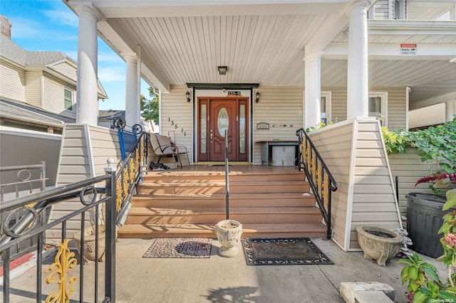 view of exterior entry featuring covered porch