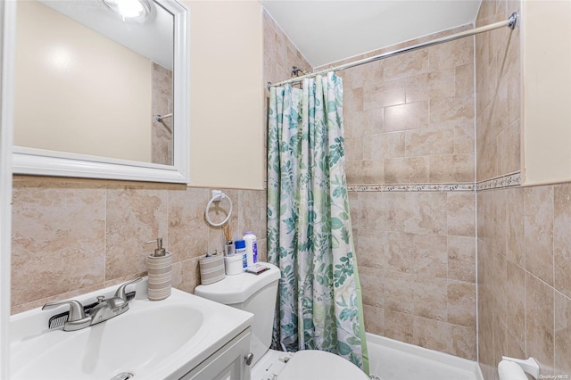 bathroom featuring curtained shower, tile walls, and toilet