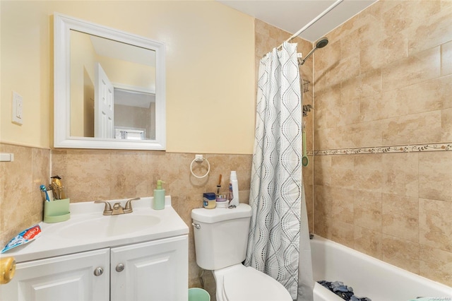 full bathroom with vanity, toilet, tile walls, and shower / tub combo with curtain