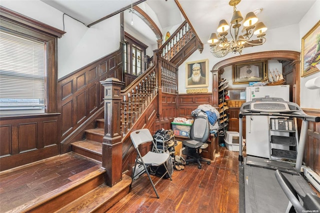 interior space with wood-type flooring and a notable chandelier