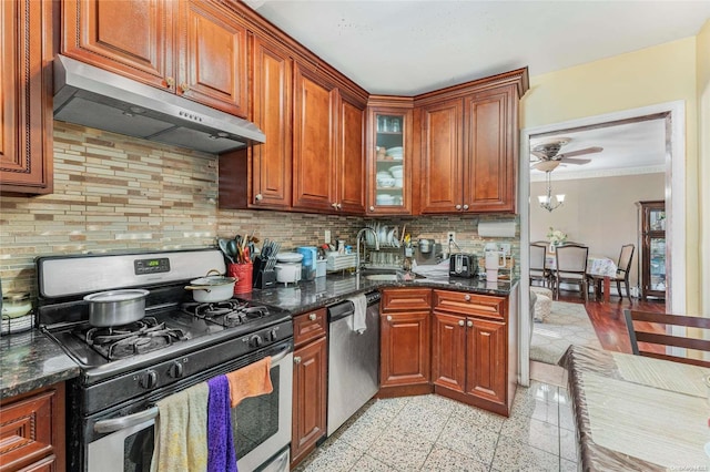 kitchen featuring tasteful backsplash, sink, dark stone counters, and appliances with stainless steel finishes