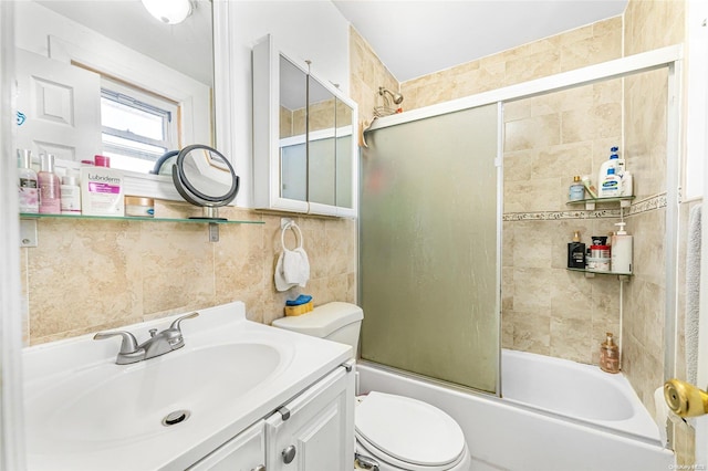 full bathroom with vanity, enclosed tub / shower combo, tile walls, and toilet