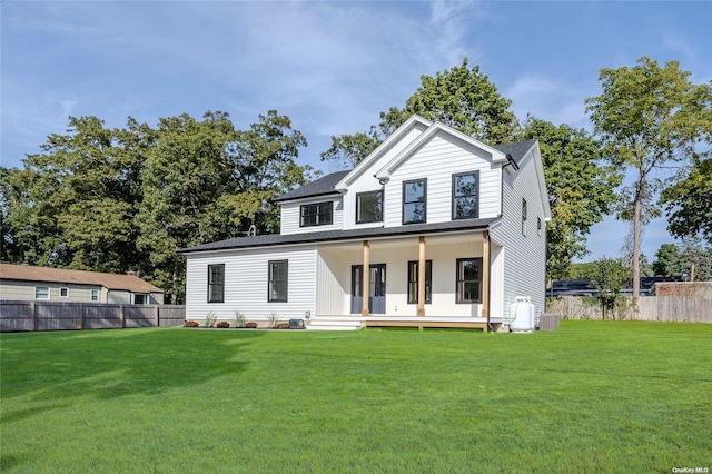 view of front of house featuring covered porch and a front lawn