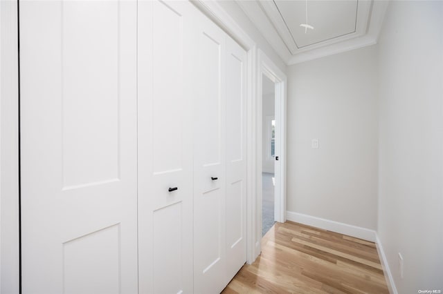 hallway with ornamental molding and light wood-type flooring