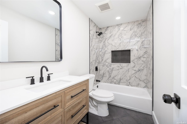 full bathroom featuring tile patterned flooring, tiled shower / bath combo, toilet, and vanity