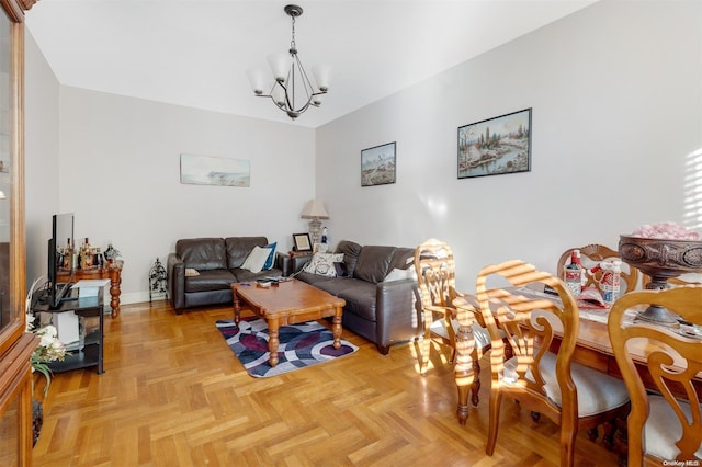 living room featuring light parquet flooring and an inviting chandelier