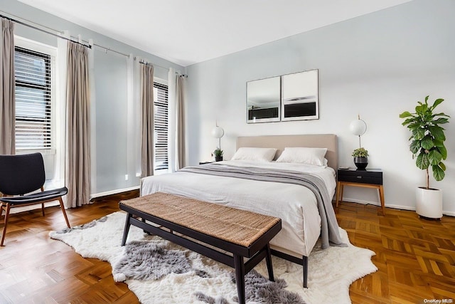 bedroom featuring dark parquet flooring