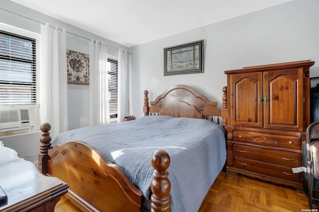 bedroom featuring cooling unit and light parquet floors