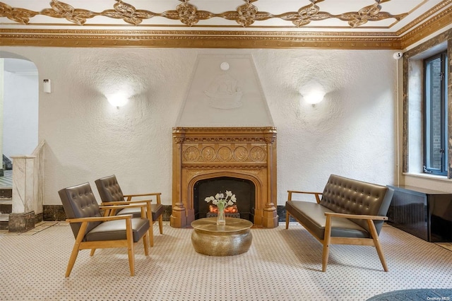 living area featuring carpet and crown molding