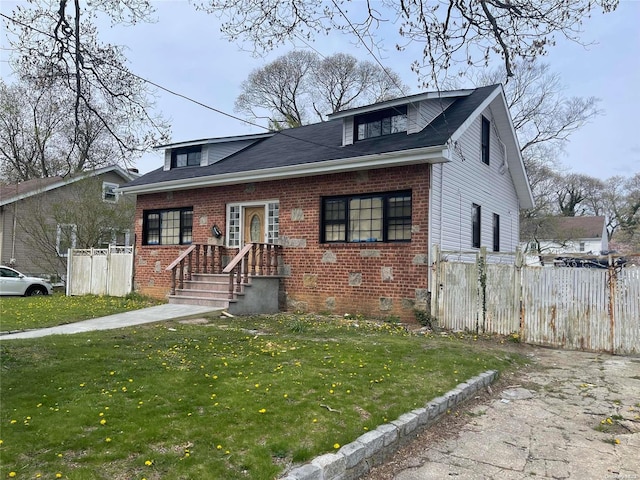 bungalow-style house with a front lawn