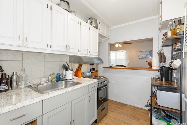 kitchen with gas stove, white cabinetry, sink, light hardwood / wood-style flooring, and exhaust hood