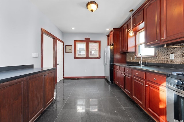 kitchen with backsplash, sink, and appliances with stainless steel finishes