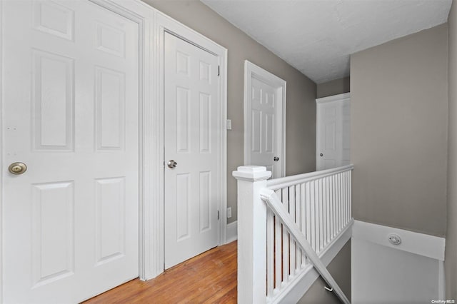 corridor with light hardwood / wood-style flooring