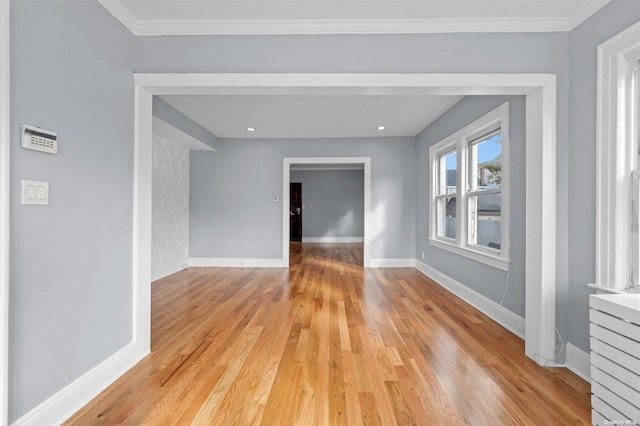 unfurnished room with ornamental molding and light hardwood / wood-style flooring