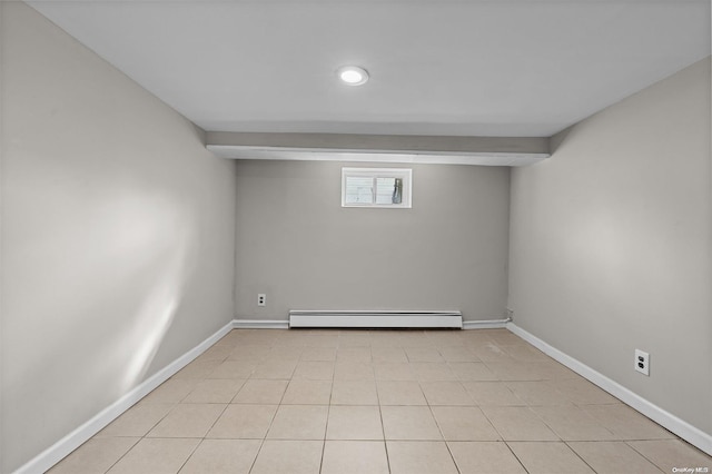 unfurnished room with light tile patterned flooring and a baseboard radiator