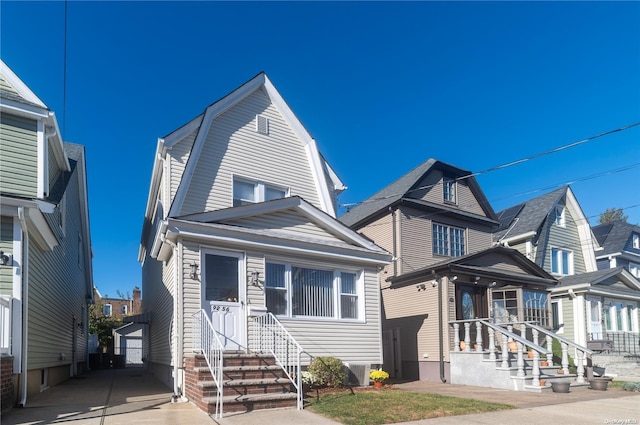 view of front of home with an outdoor structure, a garage, and central air condition unit