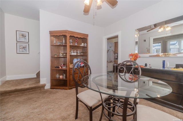 dining area featuring carpet and ceiling fan