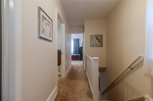 hallway featuring light carpet