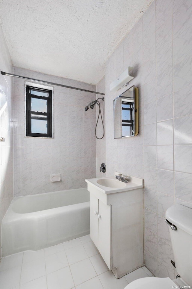 full bathroom featuring a textured ceiling, vanity, tile walls, and toilet