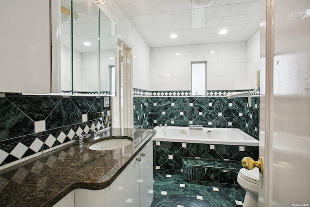 full bathroom with vanity, toilet, and tile walls