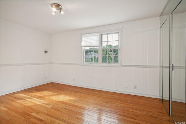 empty room with wood-type flooring