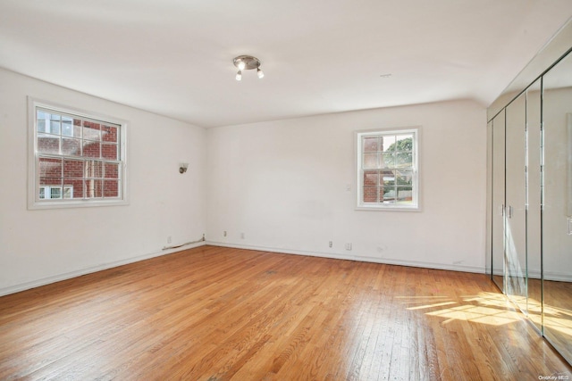 unfurnished room with light hardwood / wood-style flooring