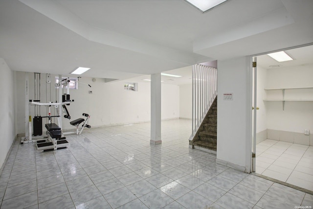 workout room featuring light tile patterned floors