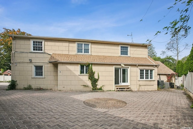 rear view of house with a patio and central AC unit