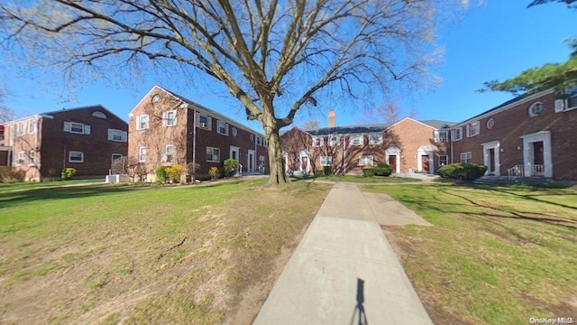 view of property's community featuring a yard