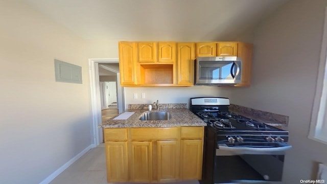 kitchen featuring gas stove and sink