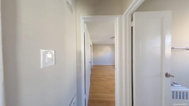 hall with hardwood / wood-style flooring