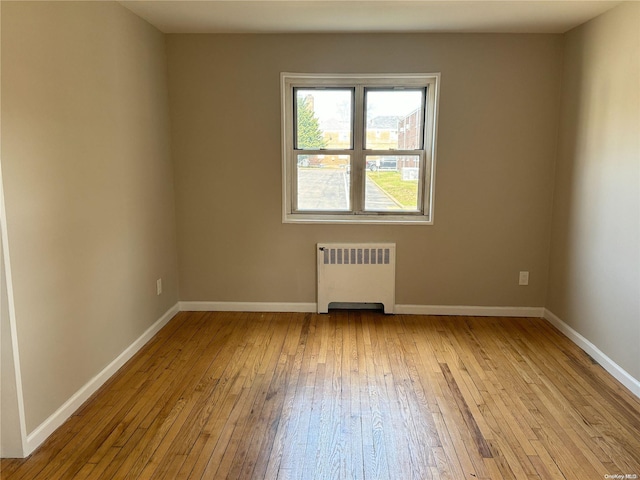 empty room with radiator and light hardwood / wood-style floors