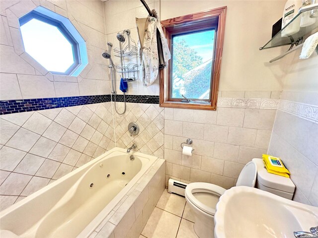 bathroom featuring toilet, tile patterned floors, a combined bath / shower with jetted tub, baseboard heating, and tile walls