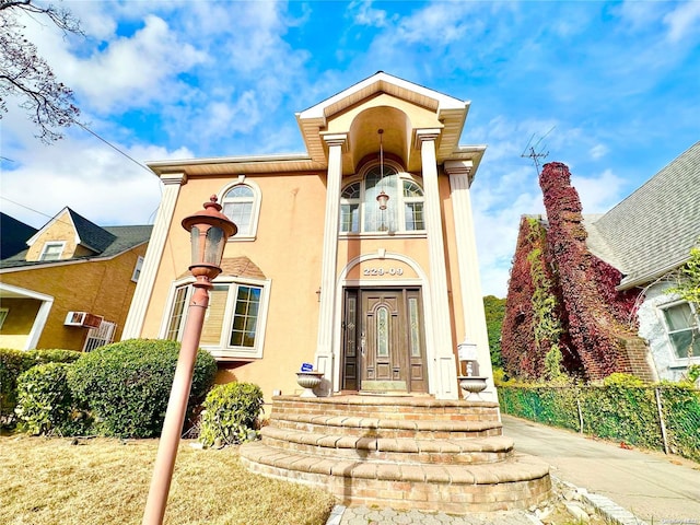 view of front of home with fence and stucco siding