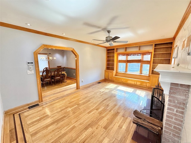 living room with baseboards, light wood-style flooring, visible vents, and crown molding