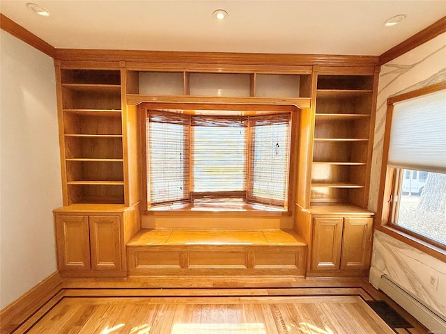 interior details featuring a baseboard heating unit, wood finished floors, and recessed lighting