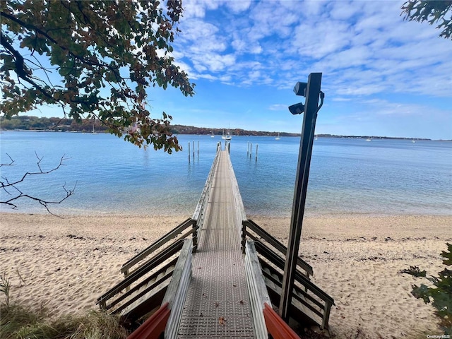 view of property's community featuring a beach view and a water view