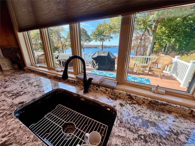 interior details featuring a water view and a sink