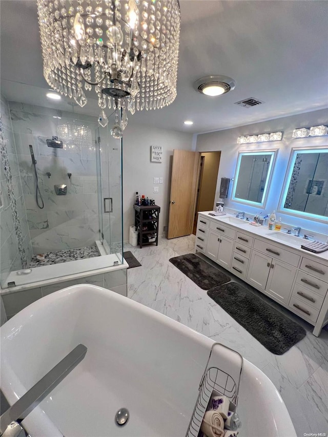 full bathroom featuring double vanity, visible vents, marble finish floor, a freestanding bath, and a shower stall