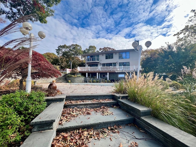 rear view of house featuring a balcony